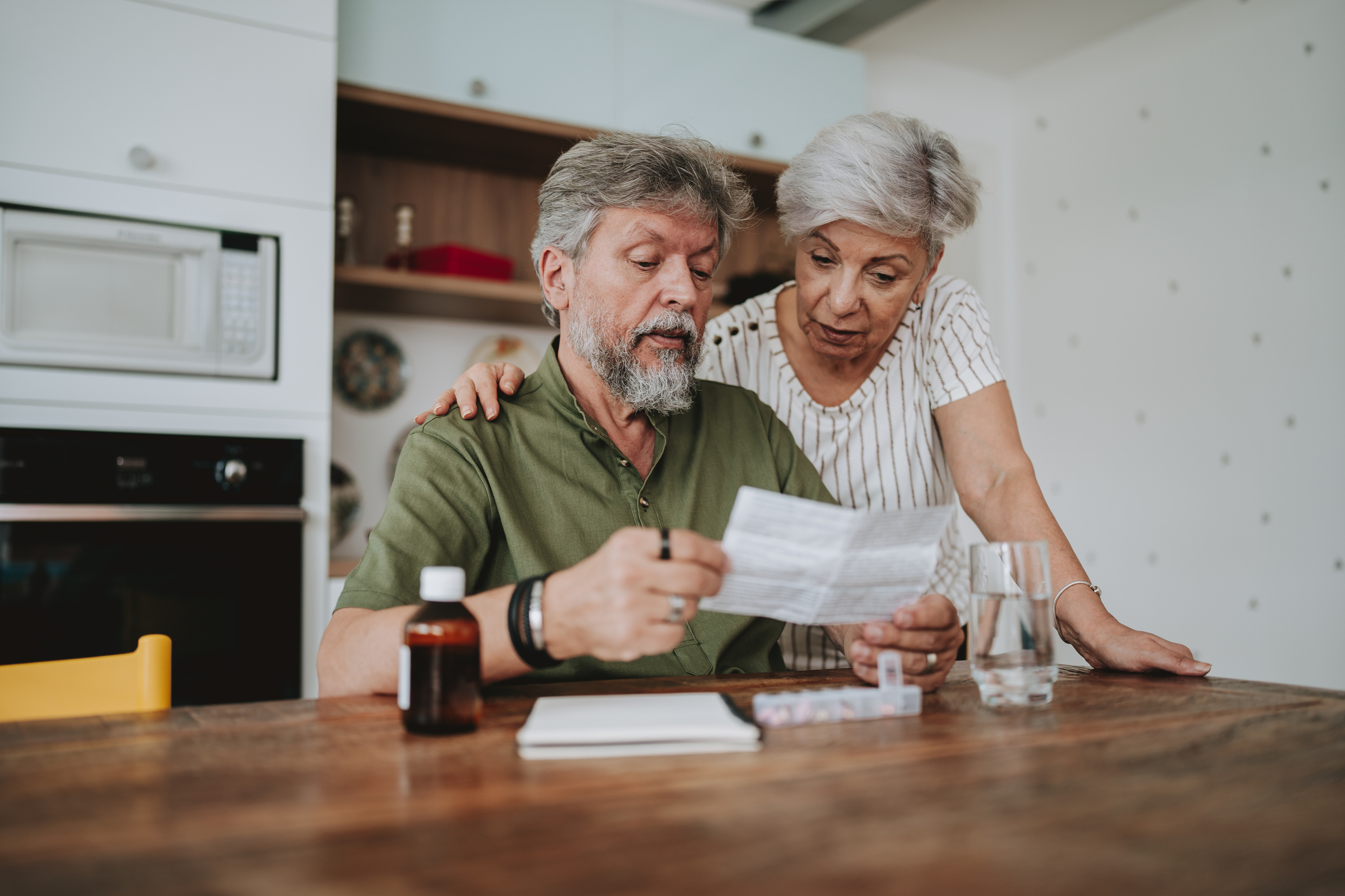 Senior couple medicating at home with medical prescription